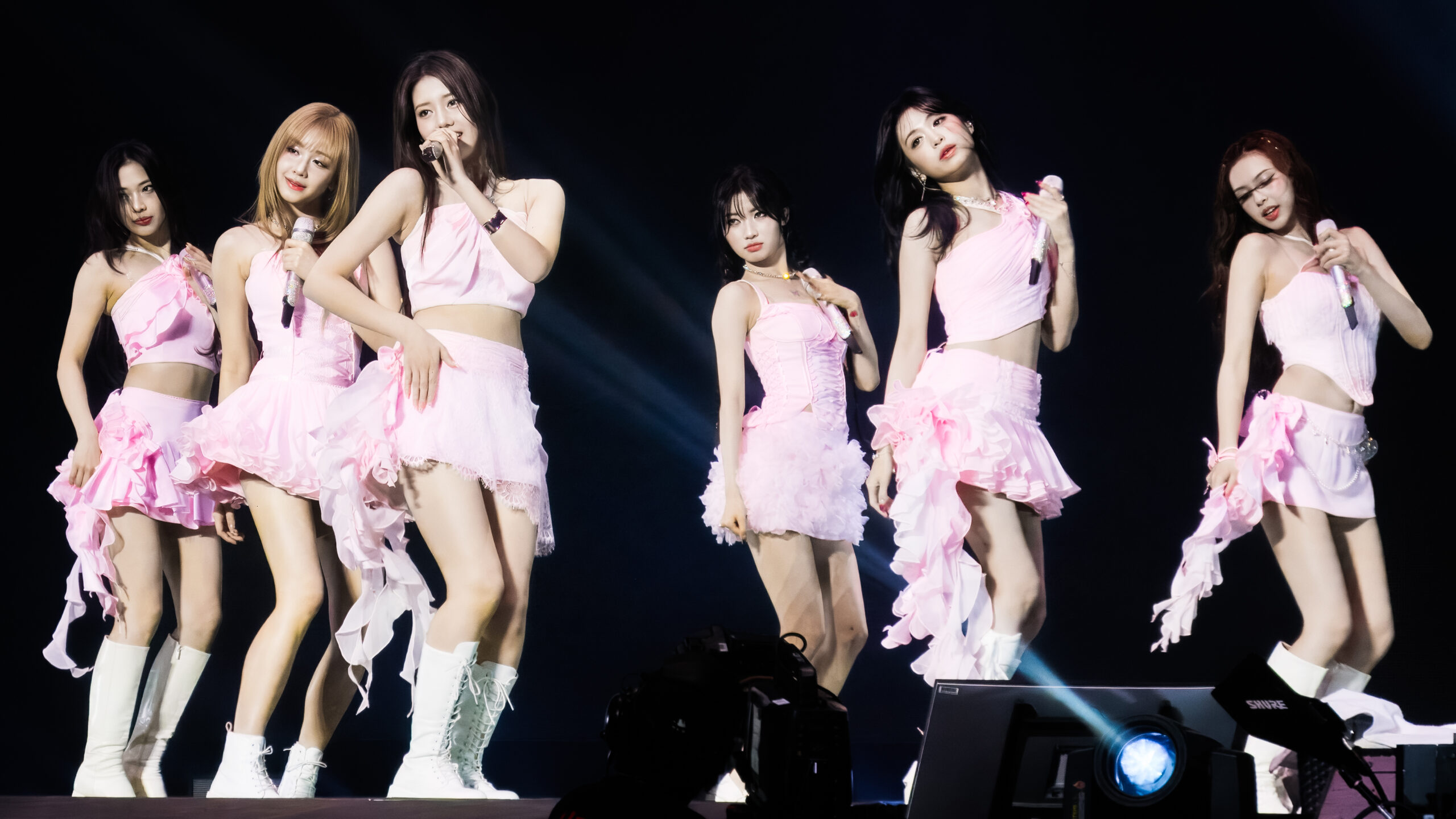 BABYMONSTER members performing in pink stage outfits in Seattle in September 2025
