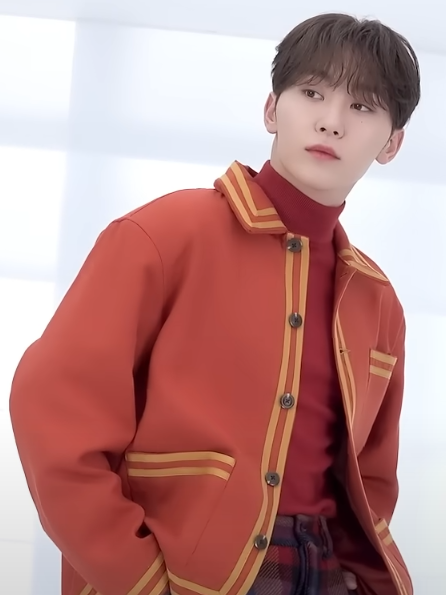 Seungkwan wearing an orange jacket in an archival 2024 image